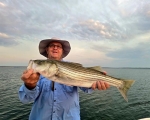 Happy angler with Lake Texoma striper, Stripers Inc. guide service.
