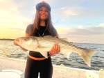 Clients showing off stripers after a Stripers Inc. guide trip.