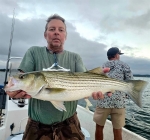 Client holding a fresh Lake Texoma striper, Stripers Inc.