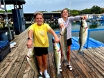Client holding a striper on the boat with Stripers Inc.